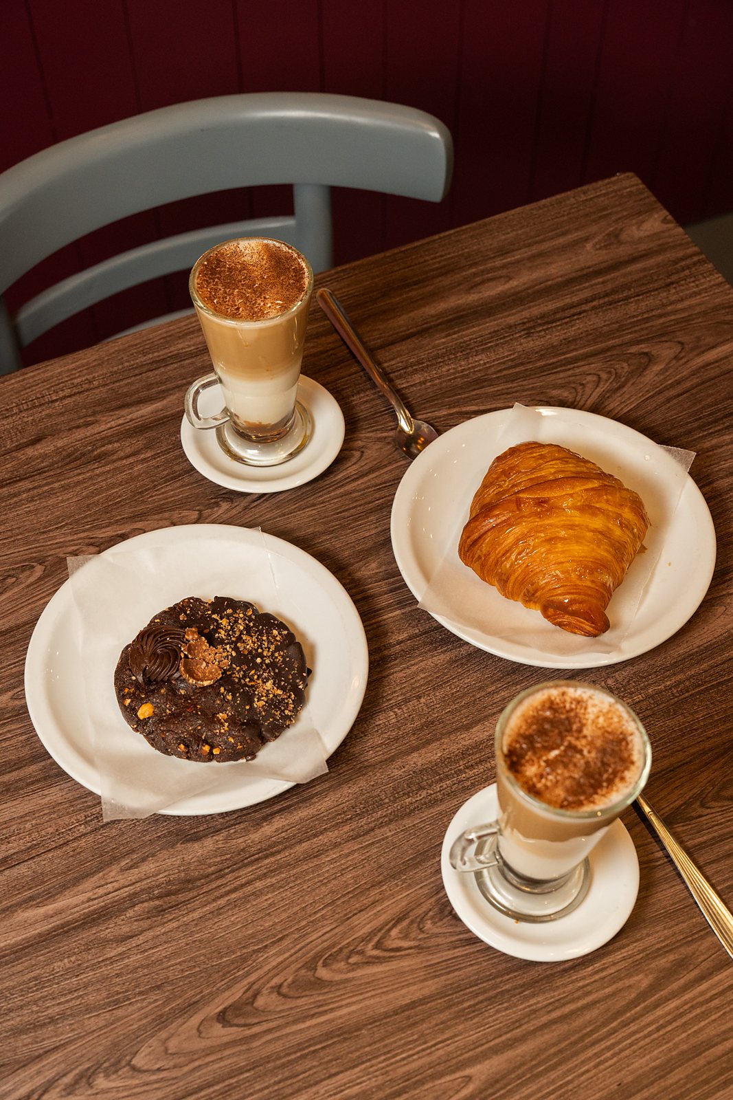 Merienda en la mesa: latte, croissant y cookie